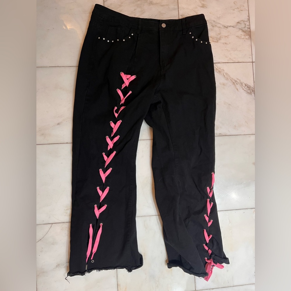 Black jeans with pink ribbon
